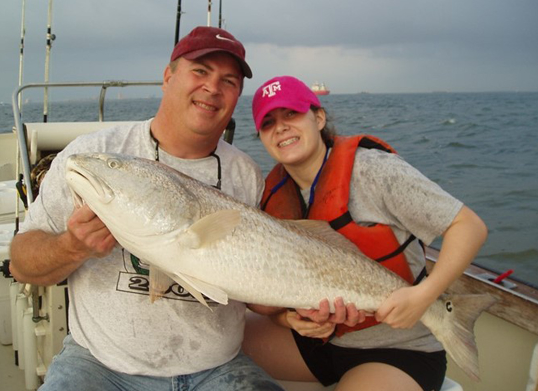 Refer Us - Independent Insurance Counselors Owner and Woman Holding a Fish Together Out in the Ocean