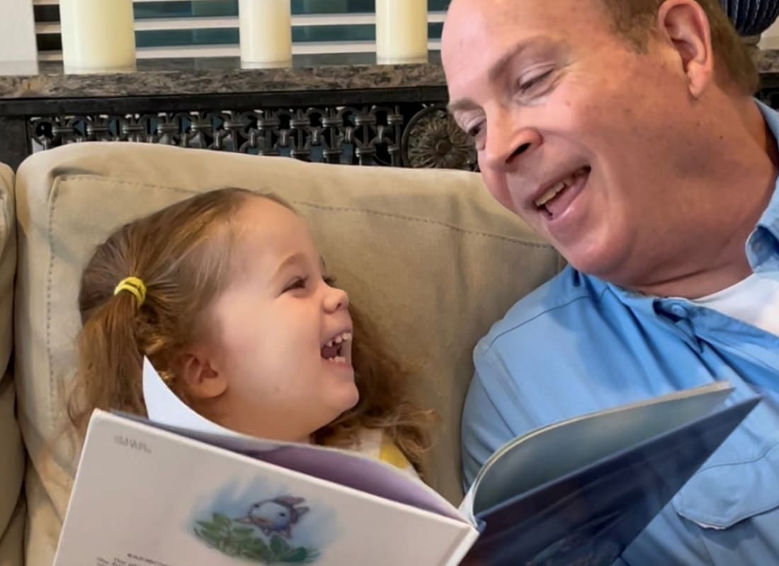 Review Us - Independent Insurance Counselors Owner and Child Laughing Together While Reading a Book