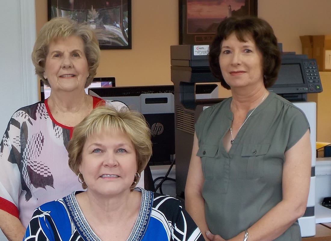 Service Center - The Ladies of the Independent Insurance Counselors Team Standing Together in Their Office